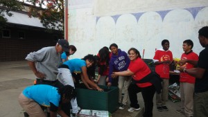 Florentino Castellon constructs and plants a raised bed with students from the cooking club.